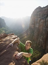 A man climbing up a rock at Red Rock