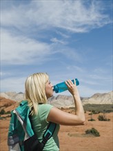 A woman at Red Rock drinking water