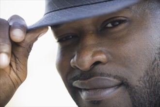 A man outdoors wearing a hat