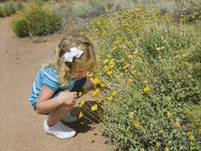 A young girl by wildflowers in Red Rock