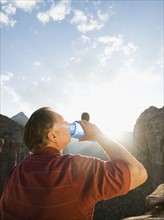 A man drinking water at Red Rock