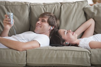 Couple in living room listening to music.