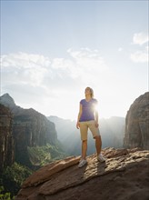 A woman standing at an apex at Red Rock