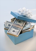 Stacks of money in a gift box.
