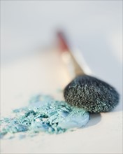 Powder beside a make up brush