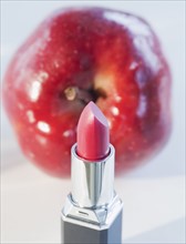Lipstick and a red apple