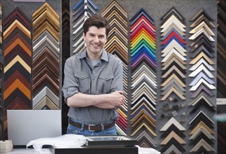 A man working at a frame store.