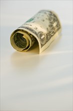 Rolled up dollar bill