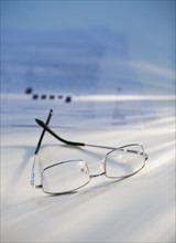 Eyeglasses near some paperwork.