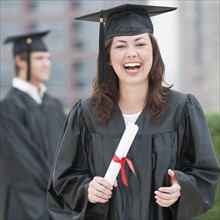 A graduate holding a diploma.