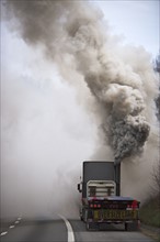 Large semi truck emitting exhaust fumes