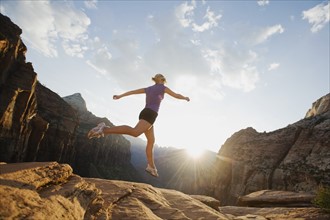 A woman jumping on rock at Red Rock
