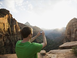 A man taking a picture at Red Rock