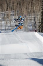 A downhill skier jumping