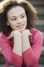 A woman outdoors on stairs smiling