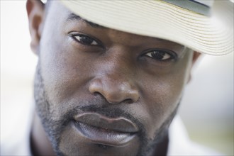 A man outdoors wearing a hat