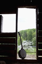 A banjo in the doorway of a cabin