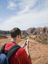 A man at Red Rock holding a GPS