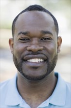 A man outdoors smiling