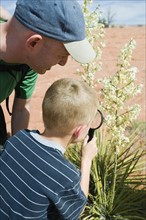 A father and son at Red Rock examining plants