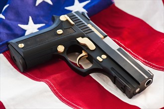A handgun on the American flag