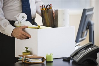 A businessman packing up desk