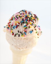 An ice cream cone with sprinkles.