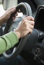 Hands on a steering wheel.