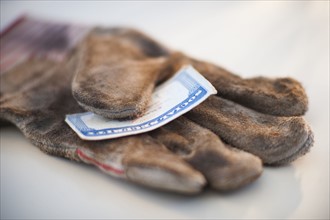 A glove with a social security card on it.