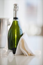 Champagne bottle with a napkin.