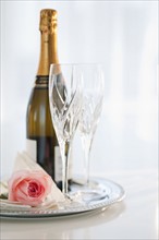 Champagne bottle and rose.