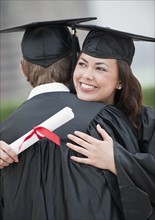 A young woman and young man graduating.