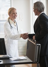Female doctor greeting salesman.
