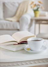 Coffee and book on table.