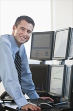 Trader at computer screens.