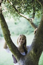 Smiling woman behind tree
