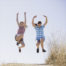 Young female friends jumping