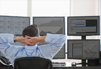 Relaxed male trader at work.