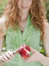 Woman peeling apple