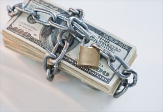 Money wrapped with lock and chain.