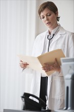 Female doctor reviewing notes.