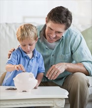 Father and child with piggybank.
