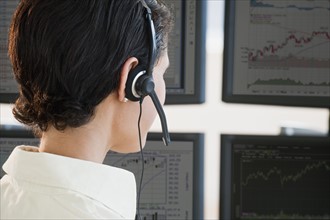 Female trader studying screens.
