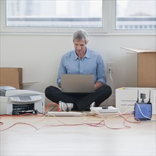 Man sitting while working on computer network.