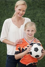 Mother and daughter with soccer ball.
