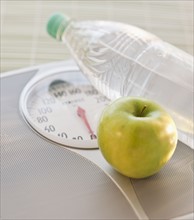Scale apple and water bottle.
