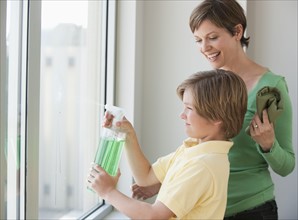 Mother and son washing windows.