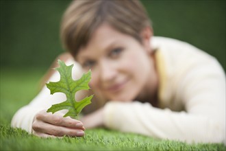 Woman looking at leaf.