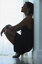 Woman leaning against wall