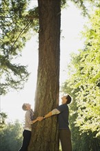 Couple hugging tree